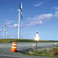 Temporary access road in the foreground of a wind farm