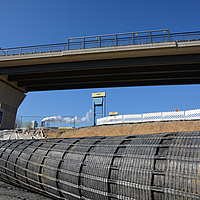 Coiled roll of Fortrac Geogrid awaits installation for soil reinforcement